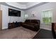 Relaxing bedroom with tray ceiling, mounted TV, and comfortable leather sofa for lounging at 61 N Village Cir, Rydal, GA 30171