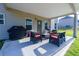 Covered patio with comfortable seating, grill, and plenty of room for outdoor gatherings at 61 N Village Cir, Rydal, GA 30171