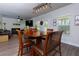 Cozy dining area with hardwood floors, stylish light fixture, and view into the living room at 61 N Village Cir, Rydal, GA 30171