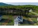 Two-story home featuring a two-car garage, neutral siding, manicured lawn, and mountain views at 61 N Village Cir, Rydal, GA 30171