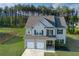 Well-maintained two-story home with attached two-car garage and a lush green lawn at 61 N Village Cir, Rydal, GA 30171
