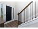 Welcoming foyer with sleek floors, staircase, and bright natural light streaming through the front door at 61 N Village Cir, Rydal, GA 30171