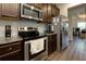 Contemporary kitchen featuring stainless steel appliances, granite countertops, and dark wood cabinets at 61 N Village Cir, Rydal, GA 30171
