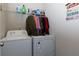 Functional laundry room with washer, dryer, and shelving at 61 N Village Cir, Rydal, GA 30171
