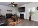 Cozy living room features a fireplace, ceiling fan, and wood-look flooring at 61 N Village Cir, Rydal, GA 30171