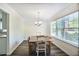 Bright dining room featuring hardwood floors, natural light, and adjacent to the kitchen at 680 Ruxbury Ct, Suwanee, GA 30024