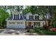 Charming two-story home featuring a well-manicured front yard and a welcoming front porch at 680 Ruxbury Ct, Suwanee, GA 30024