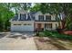 Charming two-story home with a two-car garage, red door and well-manicured lawn at 680 Ruxbury Ct, Suwanee, GA 30024