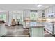 Open-concept kitchen with an island, updated appliances, and plenty of natural light at 680 Ruxbury Ct, Suwanee, GA 30024