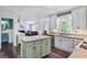 Well-lit kitchen with a kitchen island and open layout flowing into the living room at 680 Ruxbury Ct, Suwanee, GA 30024