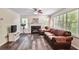 Cozy living room featuring a fireplace, leather furnishings, and lots of natural light at 680 Ruxbury Ct, Suwanee, GA 30024