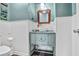 Stylish powder room features a vessel sink and light-blue vanity, complemented by wainscoting and modern fixtures at 680 Ruxbury Ct, Suwanee, GA 30024
