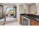 Wet bar area with granite countertop, dark wood cabinets, and access to the patio at 1954 Saxon Valley Ne Cir, Brookhaven, GA 30319