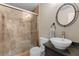 Elegant bathroom featuring a glass-enclosed shower, and a stylish sink with modern fixtures at 1954 Saxon Valley Ne Cir, Brookhaven, GA 30319
