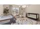 Light-filled Bedroom featuring a crib, armchair, changing station, and decorative accents at 1954 Saxon Valley Ne Cir, Brookhaven, GA 30319