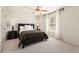 Cozy bedroom features neutral walls, ceiling fan, window, and comfortable bedding at 1954 Saxon Valley Ne Cir, Brookhaven, GA 30319