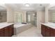 Bright main bathroom featuring a soaking tub, glass-enclosed shower, and double vanities at 1954 Saxon Valley Ne Cir, Brookhaven, GA 30319