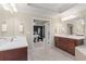 Elegant bathroom with double vanities, soaking tub, and a glimpse into the bedroom at 1954 Saxon Valley Ne Cir, Brookhaven, GA 30319