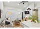Open-concept living room with vaulted ceiling, sleek ceiling fan, and a view into the kitchen with a marble island at 198 Clay Se St # G, Atlanta, GA 30317