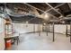 Spacious unfinished basement with exposed ceiling beams and industrial-style lighting at 2301 Crestcliff Dr, Tucker, GA 30084