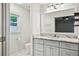 Bright bathroom featuring updated vanity with marble countertops, and white tile flooring at 2301 Crestcliff Dr, Tucker, GA 30084
