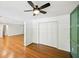 Bright bedroom featuring hardwood floors, ceiling fan, and a closet at 2301 Crestcliff Dr, Tucker, GA 30084