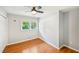 A cozy bedroom featuring hardwood floors and a window with a backyard view at 2301 Crestcliff Dr, Tucker, GA 30084