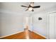 Bedroom with hardwood floors, ceiling fan, and double door closet at 2301 Crestcliff Dr, Tucker, GA 30084