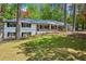 Charming painted brick home featuring a front porch and a beautifully landscaped front yard at 2301 Crestcliff Dr, Tucker, GA 30084