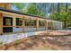 Charming front porch with black railing, wood support beams, and a painted white brick facade at 2301 Crestcliff Dr, Tucker, GA 30084