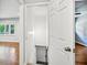 Hallway leading to stairs, connecting rooms with hardwood floors and natural light from a nearby window at 2301 Crestcliff Dr, Tucker, GA 30084