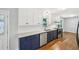 Modern kitchen with stainless steel appliances, granite counters, and white and navy cabinets at 2301 Crestcliff Dr, Tucker, GA 30084