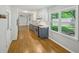 Bright kitchen with stainless steel appliances, two-tone cabinets, hardwood floors, and backyard view at 2301 Crestcliff Dr, Tucker, GA 30084