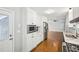 Kitchen featuring stainless appliances, white cabinets, marble countertops, and hardwood flooring at 2301 Crestcliff Dr, Tucker, GA 30084