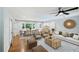 Bright living room features hardwood floors, a modern ceiling fan, and abundant natural light at 2301 Crestcliff Dr, Tucker, GA 30084