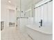 Luxurious bathroom featuring freestanding tub, separate glass shower, and patterned hexagon tile flooring at 5315 Hendrix Rd, Cumming, GA 30040