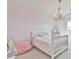 bedroom with a white bed frame, whimsical chandelier, and a cute toy castle at 5315 Hendrix Rd, Cumming, GA 30040
