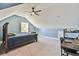 Bright bedroom with an angled ceiling, large window, desk, and chair at 5315 Hendrix Rd, Cumming, GA 30040