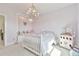 Charming bedroom featuring a built-in window seat, elegant chandelier, and playful decor at 5315 Hendrix Rd, Cumming, GA 30040
