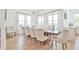 Elegant dining room featuring a rustic wooden table and comfortable seating with bright windows at 5315 Hendrix Rd, Cumming, GA 30040