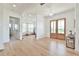 Bright entryway with light wood floors, stylish chandelier, and beautiful french doors leading to outdoor views at 5315 Hendrix Rd, Cumming, GA 30040