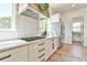 Modern kitchen featuring stainless steel appliances, custom cabinetry, and light hardwood flooring at 5315 Hendrix Rd, Cumming, GA 30040