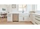 Well-lit kitchen featuring a farmhouse sink, stainless steel dishwasher, and white cabinetry at 5315 Hendrix Rd, Cumming, GA 30040