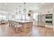 Gourmet kitchen boasts a large center island, stainless steel appliances, and stylish pendant lighting at 5315 Hendrix Rd, Cumming, GA 30040