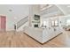 Open-concept living room with soaring ceilings, fireplace, and view of the upstairs loft at 5315 Hendrix Rd, Cumming, GA 30040