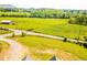 Expansive property featuring lush green pastures, mature trees, and a picturesque distant mountain view at 5315 Hendrix Rd, Cumming, GA 30040