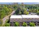 Aerial view of townhomes nestled among lush trees with a cityscape in the background at 57 Weston Dr # 13, Atlanta, GA 30328