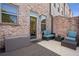 Cozy brick back patio featuring outdoor seating and a storage container for convenient outdoor living at 57 Weston Dr # 13, Atlanta, GA 30328