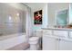 Bright bathroom featuring a tub with grey tiling and a vintage print on the wall at 57 Weston Dr # 13, Atlanta, GA 30328