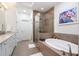 Elegant bathroom featuring double sinks, a standalone tub, and a glass-enclosed shower at 57 Weston Dr # 13, Atlanta, GA 30328